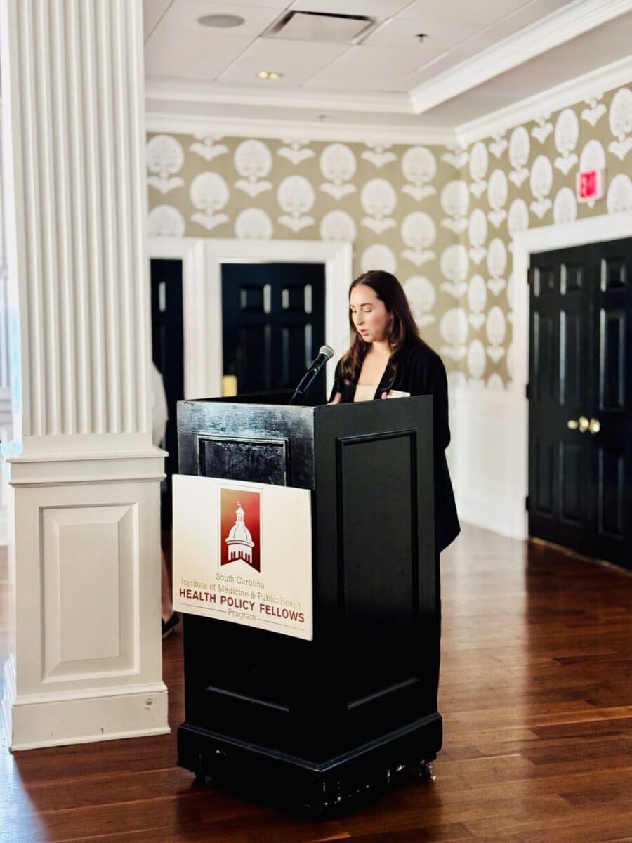 One woman speaking at a podium.